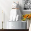 cat urn: white cat urn is on the desk